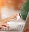 Hands holding credit card and using laptop Payment Gateway Integration