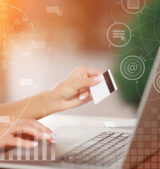 Hands holding credit card and using laptop Payment Gateway Integration