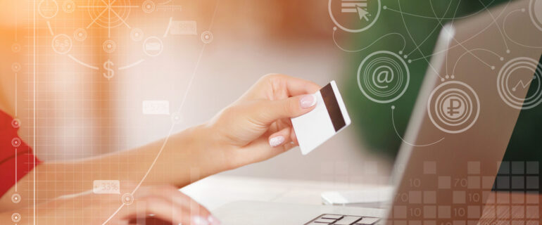 Hands holding credit card and using laptop Payment Gateway Integration