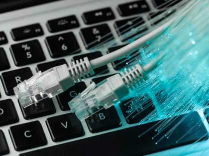 blue-optic-fiber-with-ethernet-cables-laptop LAN vs WAN Networking