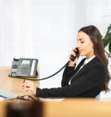 side-view-young-woman-holding-pencil-hand-talking-telephone IP-based telephone system for Businesses in Dubai