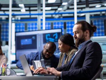 Man using laptop to write factory research and development data report : IT infrastructure setup Dubai office server networking 2026