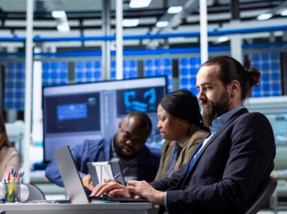 Man using laptop to write factory research and development data report : IT infrastructure setup Dubai office server networking 2026