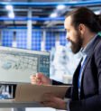 Supervisor inspecting solar plant machinery, looking over documentation files : IT infrastructure setup cost Dubai office 2026 price guide